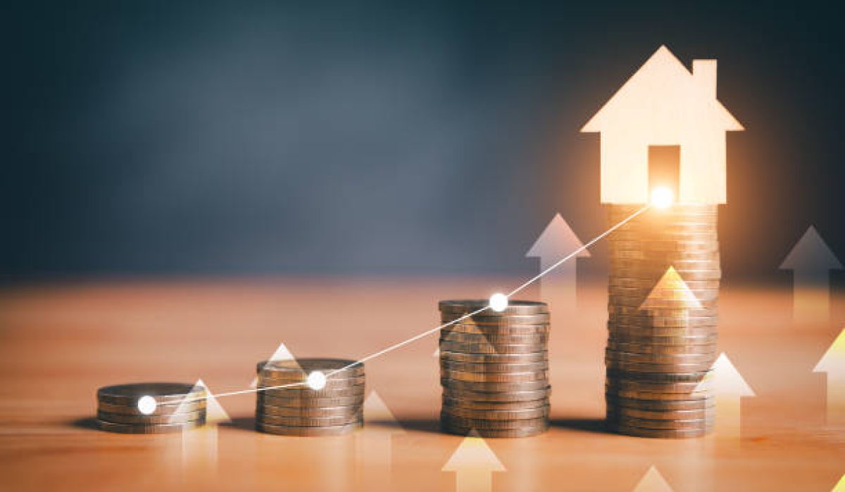 Stacks of coins with glowing house icon and upward arrows, symbolizing real estate investment growth.